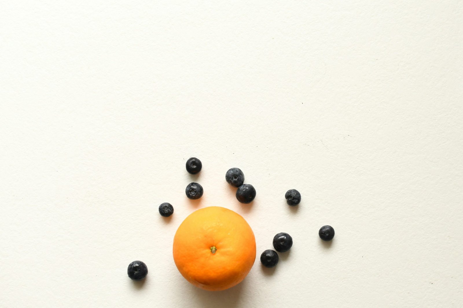 orange fruit on white surface